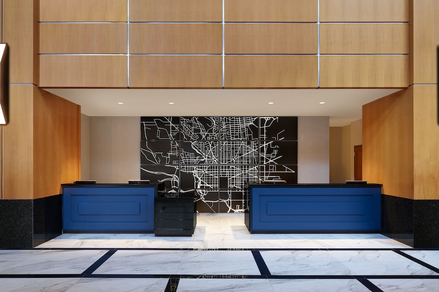 modern lobby and front desk with a full-wall black and white map of DC behind it