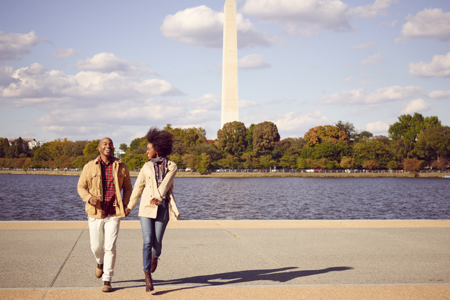 Two People walking along body of water 