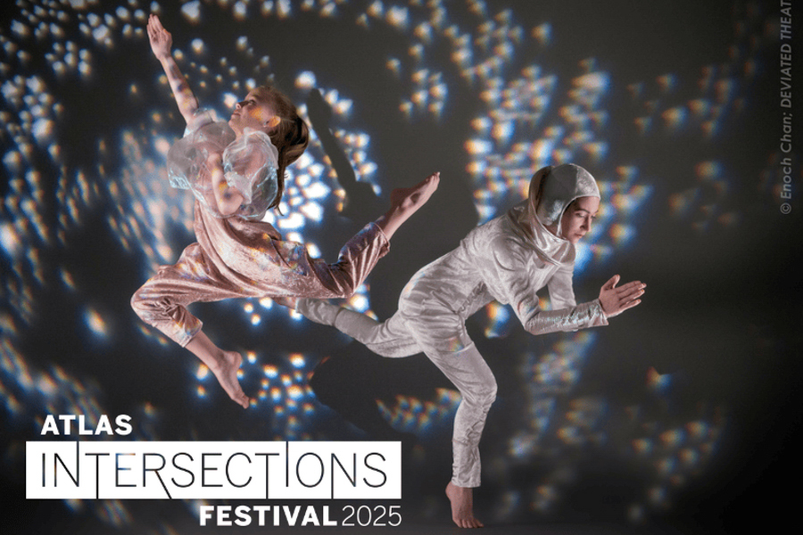 Two dancers in elegant, futuristic costumes perform a dynamic pose against a dark background scattered with colorful light reflections, promoting the Atlas Intersections Festival 2025.