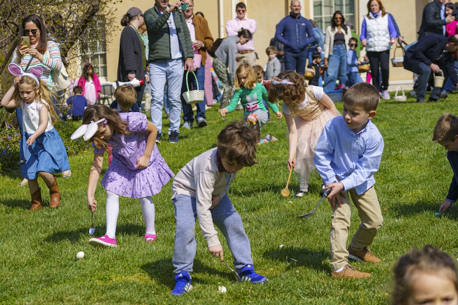 Children look for easter eggs on the lawn of Tudor Place. 