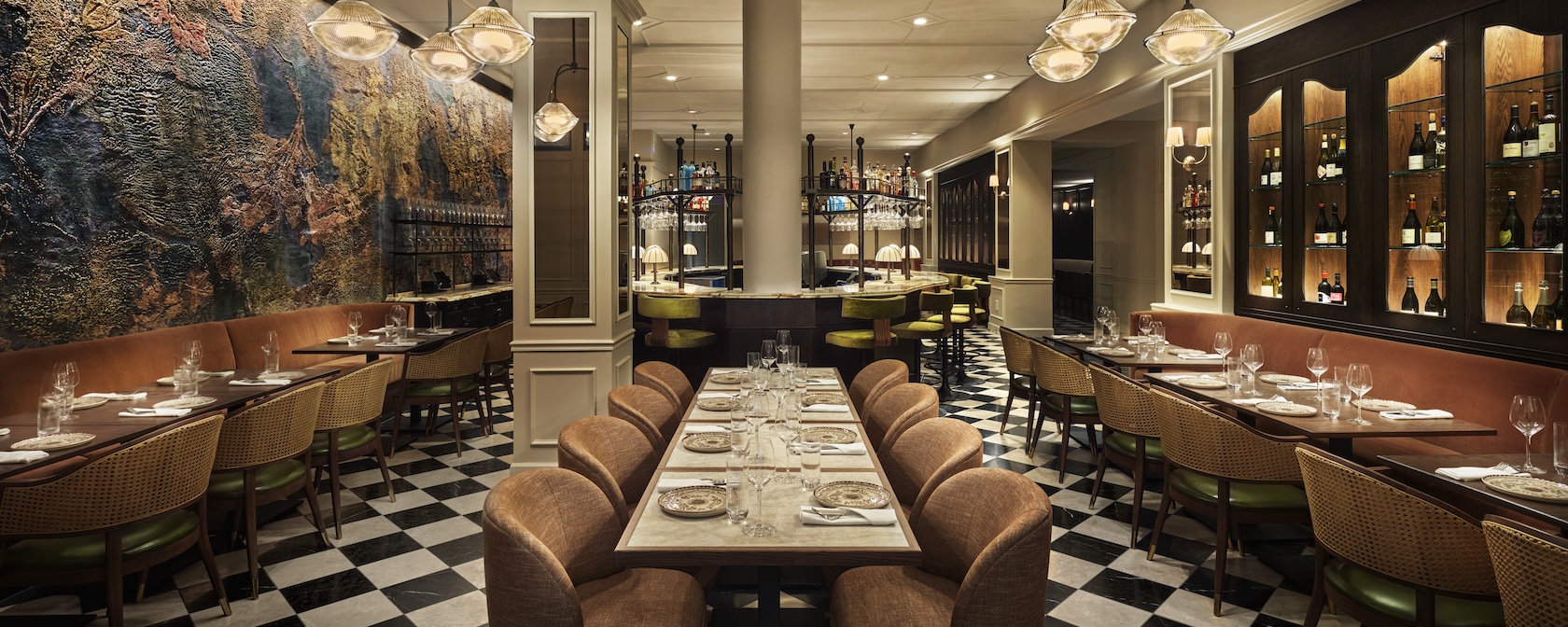 Elegant restaurant interior at Sixty DC featuring warm lighting, modern decor and a central bar with high stools.