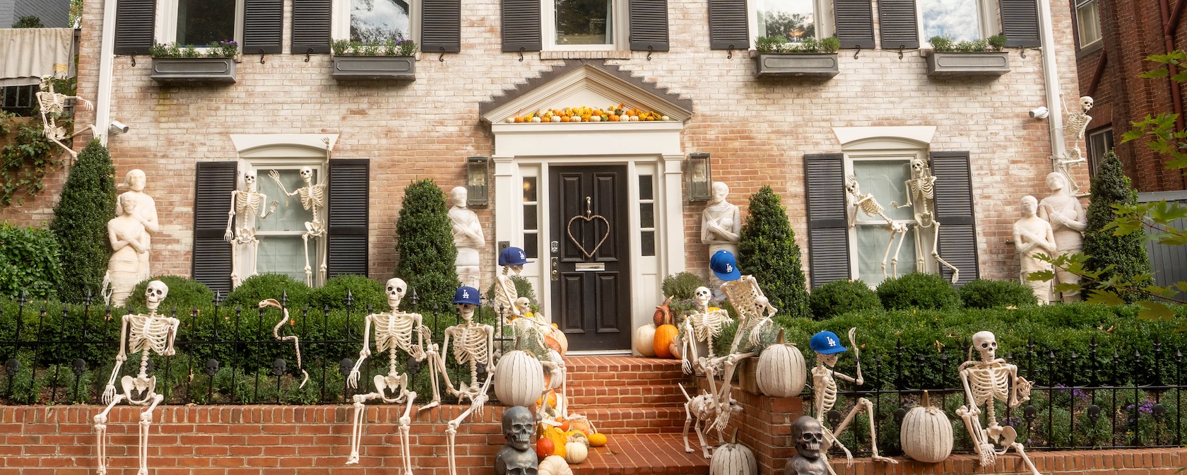 Skeletons and pumpkins decorate the front of a historic home in Georgetown.