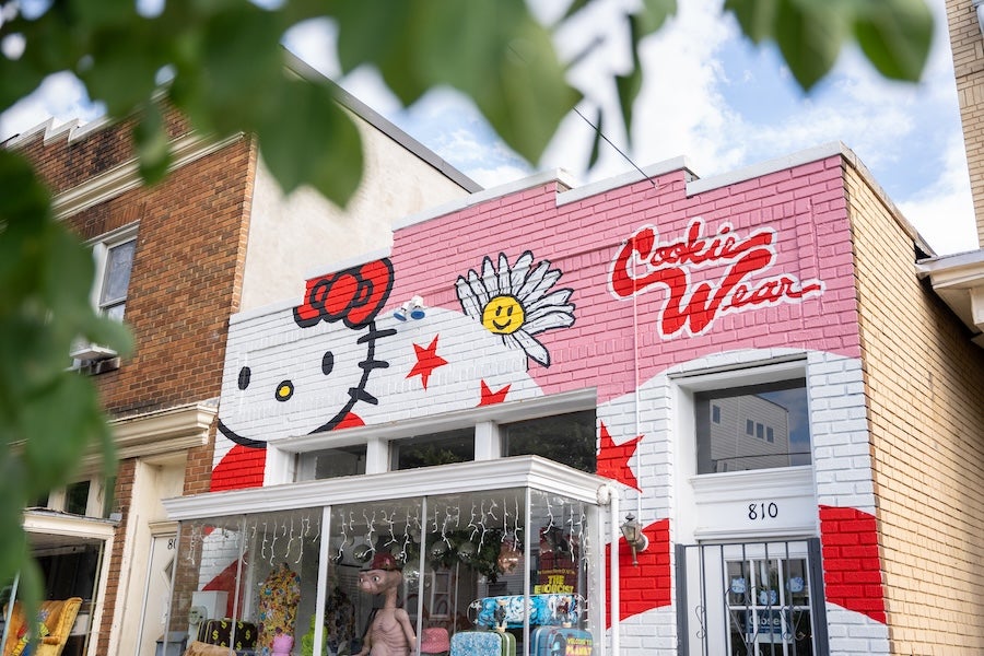 Exterior of Cookie Wear featuring a colorful mural with playful graphics on a neighborhood storefront in Washington, DC.