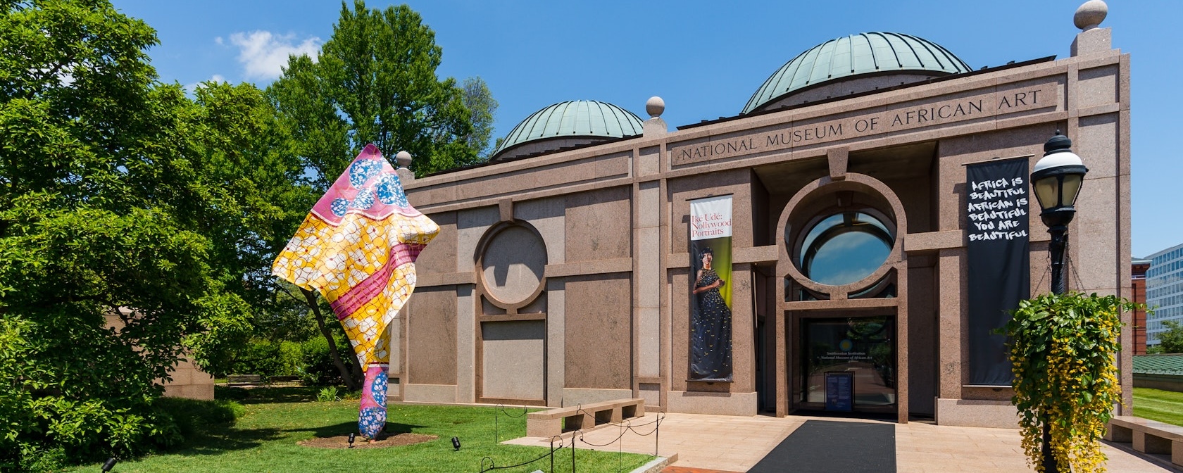 An exterior view of the Smithsonian's National Museum of African Art on a sunny day.
