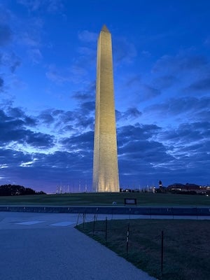 Washington Monument at dusk under a cloudy blue sky