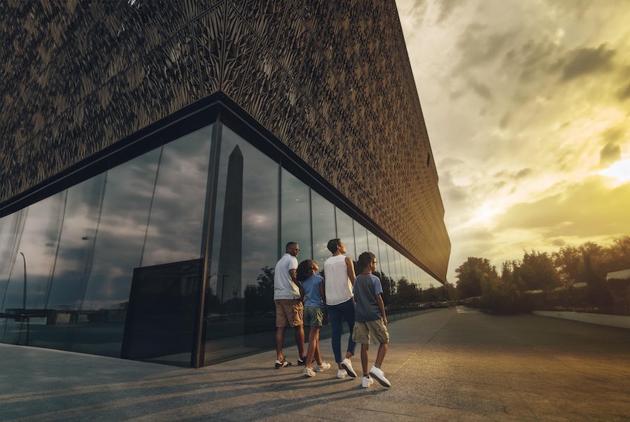 Family walking by the National Museum of African American History and Culture in Washington DC 