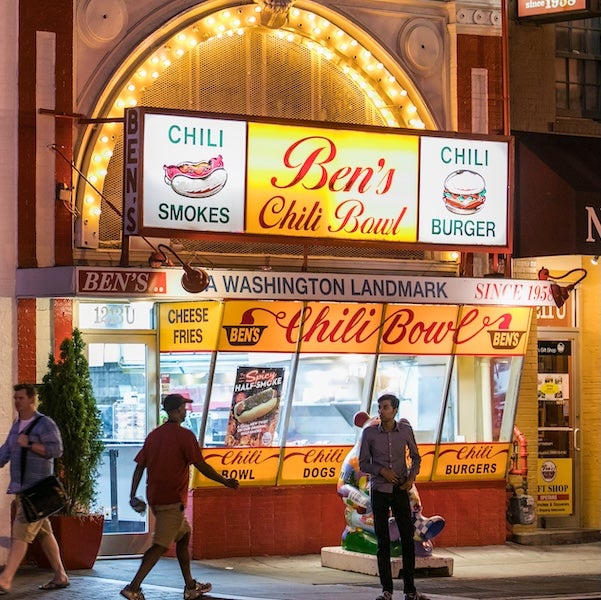 Ben's Chili Bowl storefront at night in Washington, DC, with glowing sign and people outside