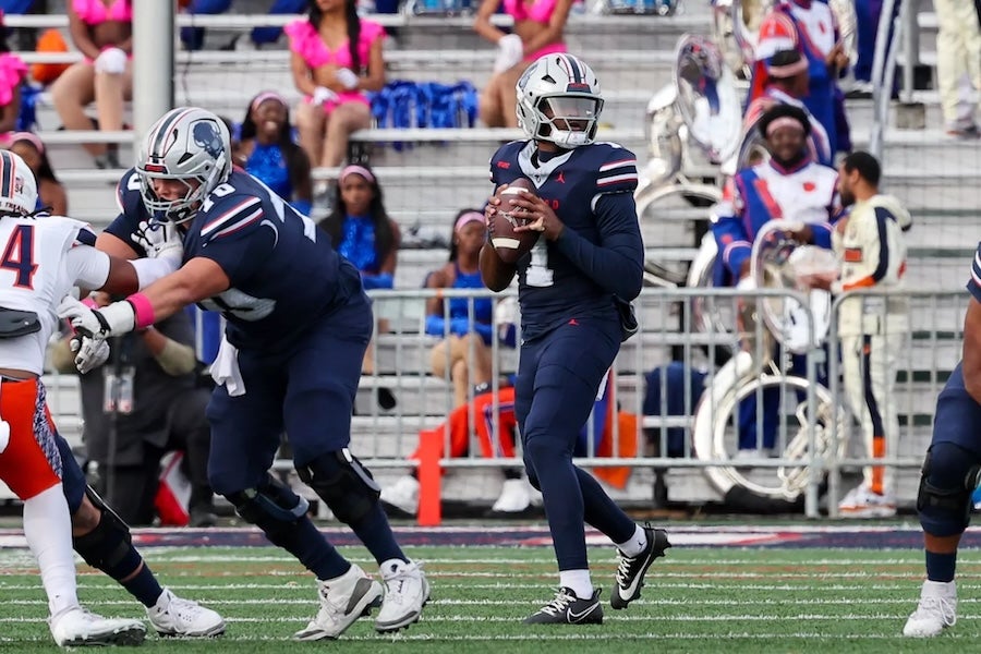Howard University football player about to throw a ball