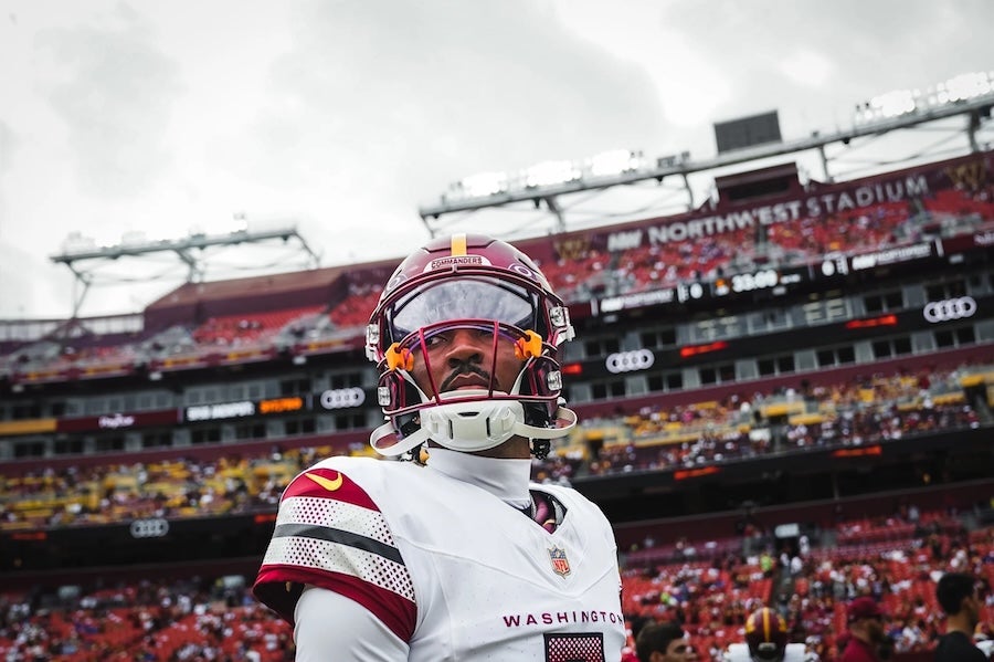 Close up photo of Jayden Daniels in Commanders gear
