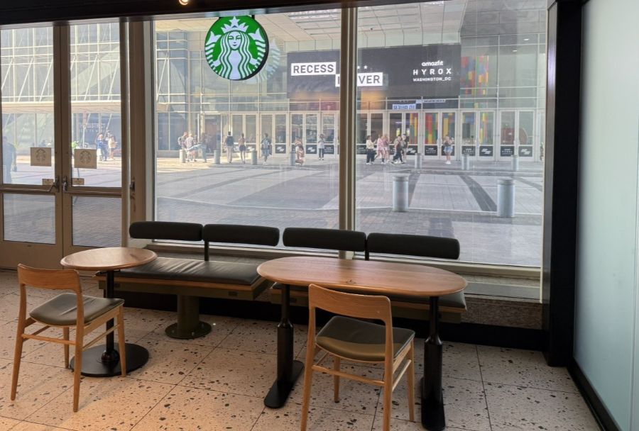 Photo of Starbucks tables by a large window looking out onto a street