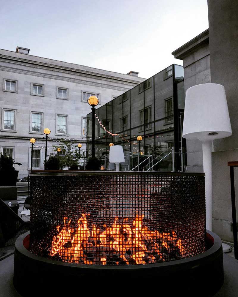 @laurenstafford_dcre - Outdoor fire pit on Dirty Habit's patio - Cozy bars and restaurants in Washington, DC