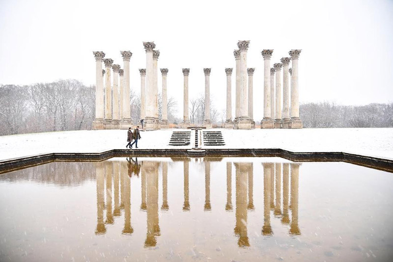 @jraefoto - Couple walking along National Capitol Columns in snowstorm at National Arboretum - Date ideas in Washington, DC