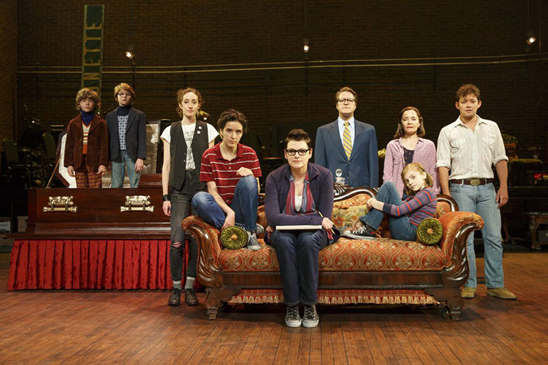 Fun Home Play cast sitting on the stage looking at the camera