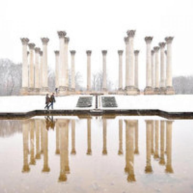 @jraefoto - Couple walking along National Capitol Columns in snowstorm at National Arboretum - Date ideas in Washington, DC