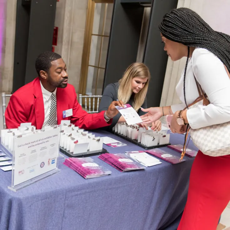 Destination DC staffing services redcoat providing assistance at registration to an event attendee in Washington, DC