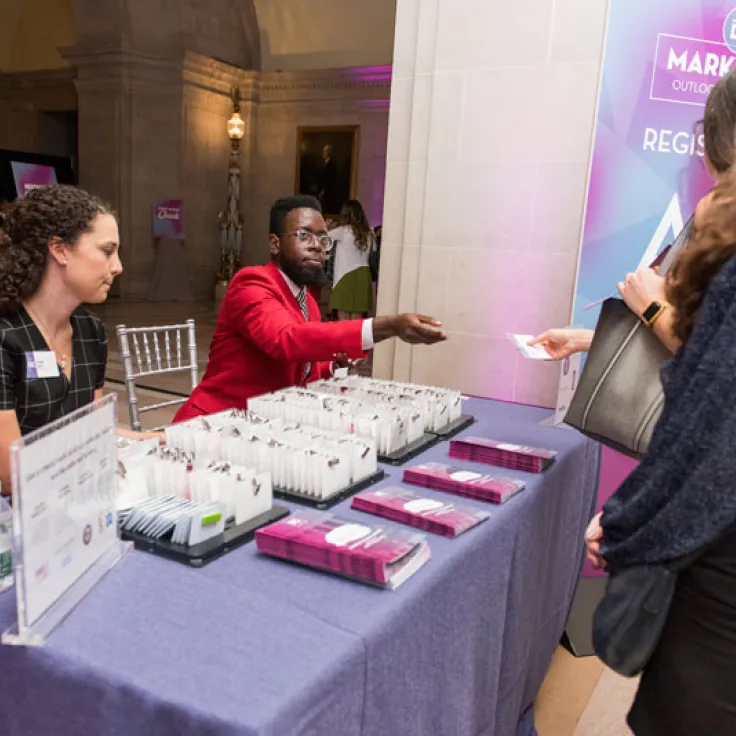 Destination DC Staffing Services redcoat assisting event attendee at registration - Staffing solutions for events in Washington, DC