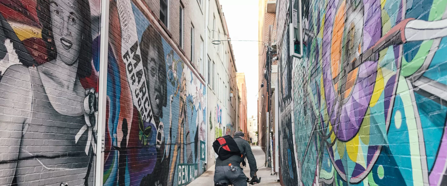 Biker going down mural alley