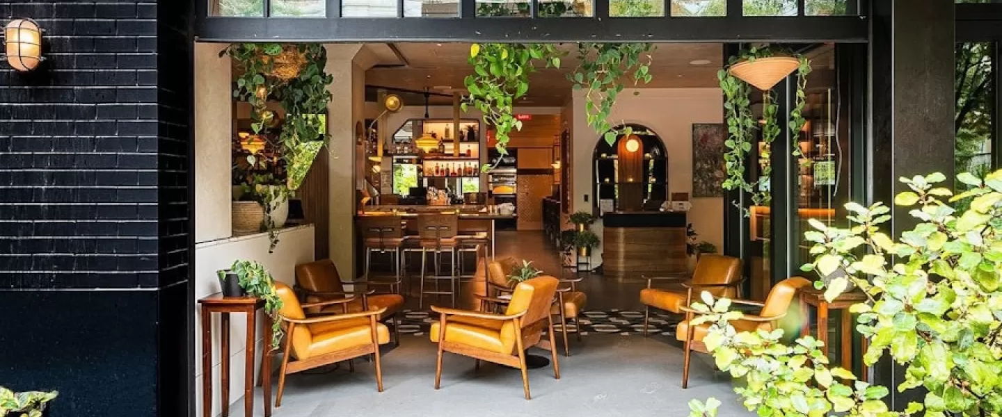indoor/outdoor patio space with plants, chic outdoor furniture, and a fire pit at Eaton DC