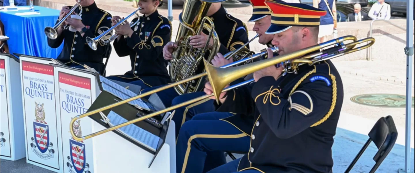 Members of the U.S. Army Brass Quintet perform in uniform during an outdoor concert in Washington, DC.