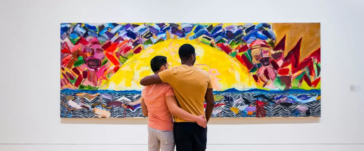 A couple looks at a colorful painting at the Phillips Collection.