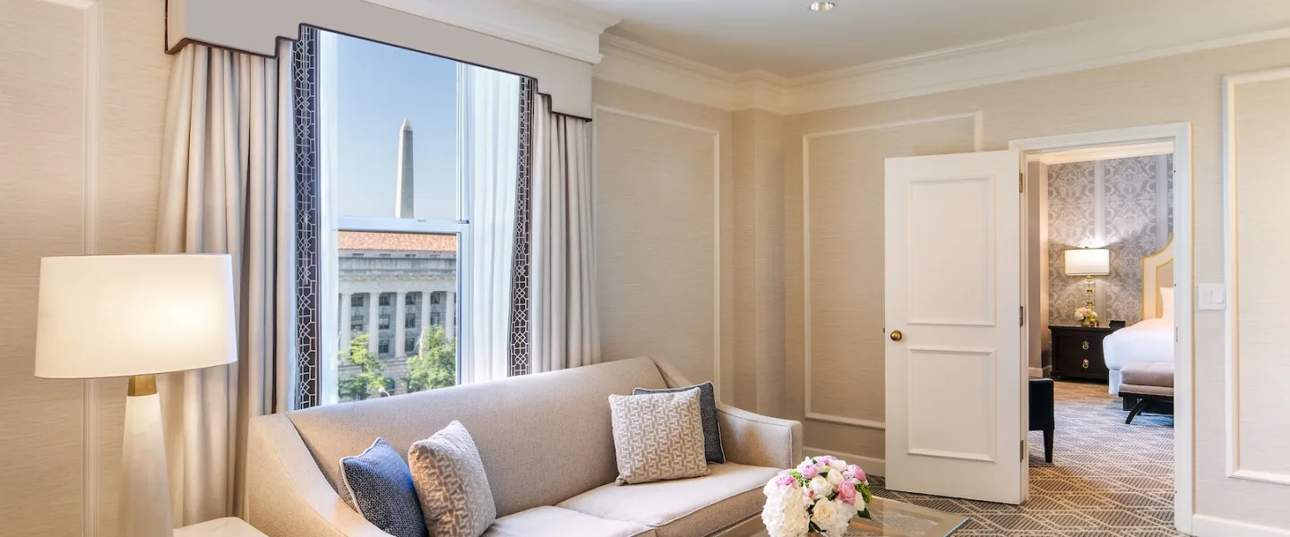 An elegant hotel room with a view of the Washington Monument. 