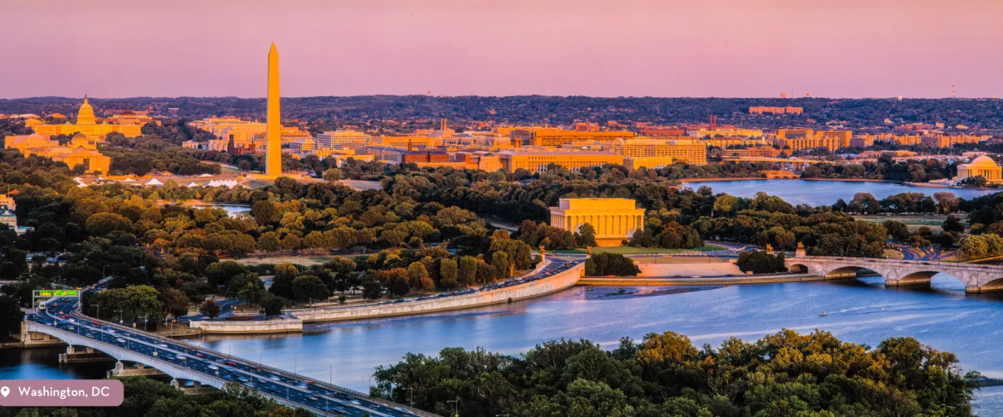 A birds eye view of the National Mall featuring the monuments and memorials during sunrise.