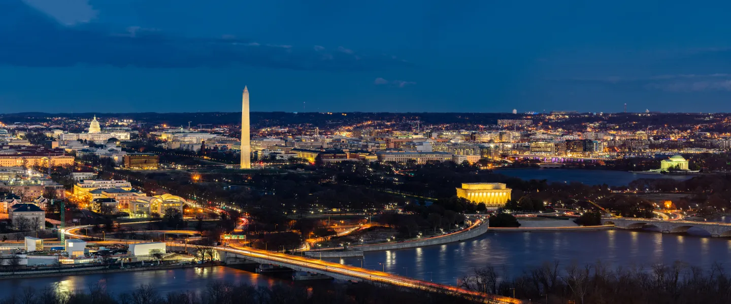 Washington, DC skyline at night, Potomac River and Washington Monument glowing
