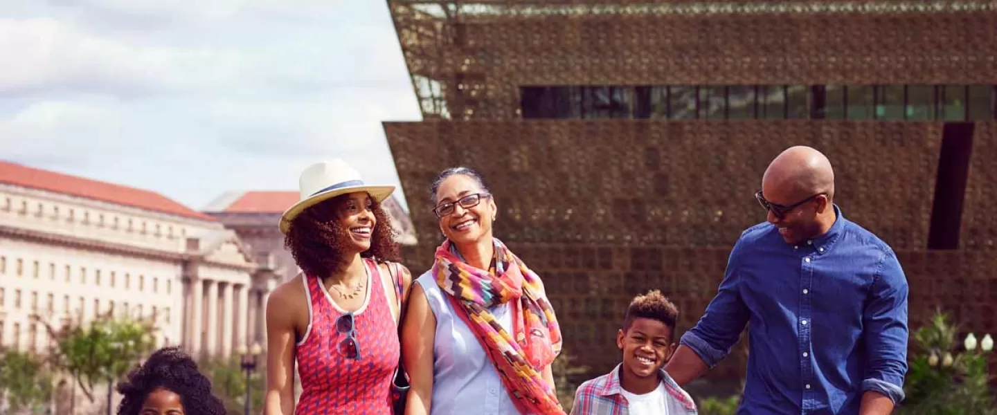 Family in front of Smithsonian NMAAHC