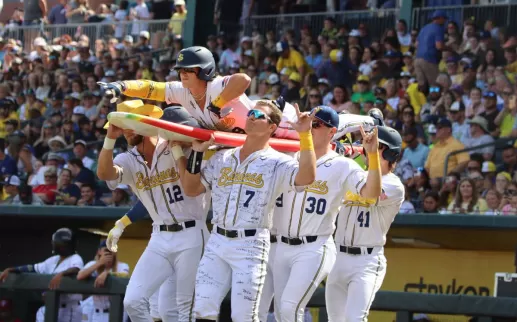 Baseball players holding a surfboard