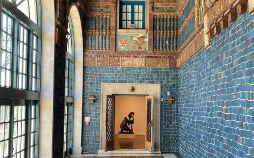 Vibrant tiled foyer at the Art Museum of the Americas with a sculpture visible through an open doorway.

