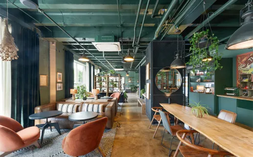 Modern lounge area at Hotel Nell in Washington, DC featuring green tones, wood furnishings, plants and cozy seating in the Union Market District
