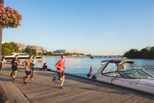 Group of people running beside Georgetown Waterfront