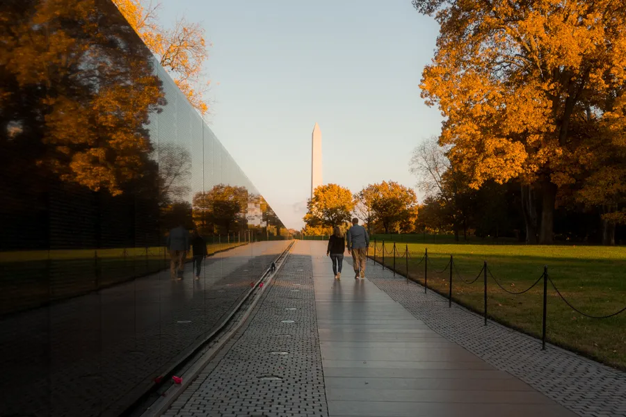 People walking across the Vietnam Veterans Memorial 