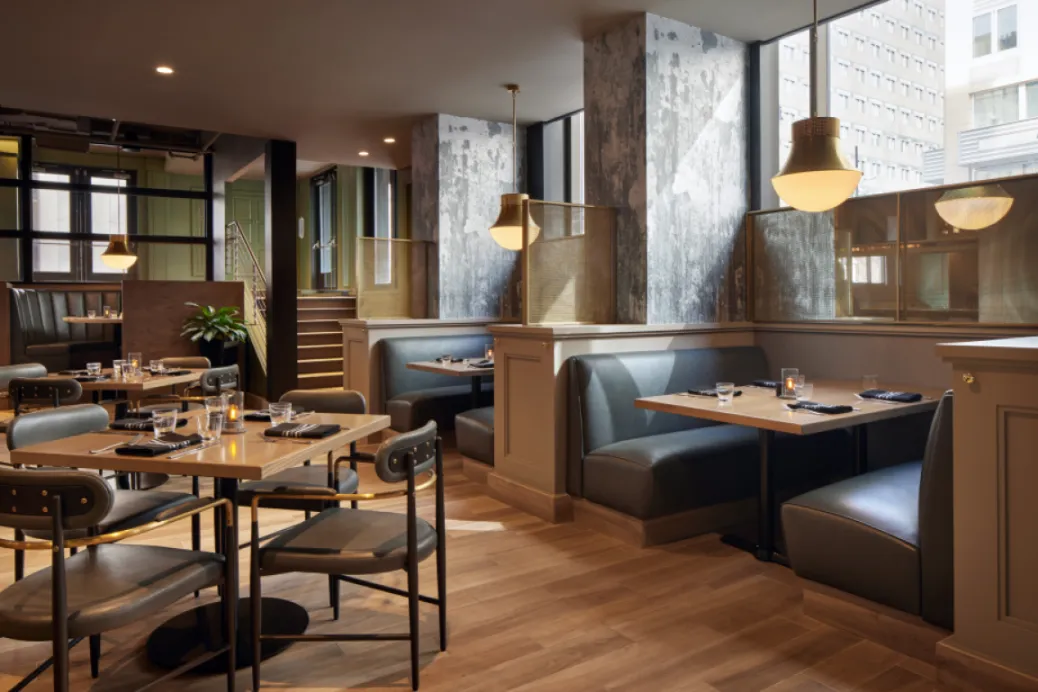 Modern dining room with cozy booths, wood floors, and warm lighting in Washington, DC.