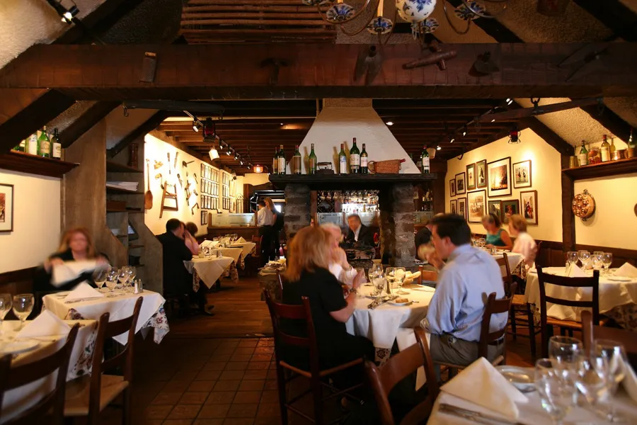Cozy French country-style dining room at La Chaumière in Washington, DC’s Georgetown neighborhood.