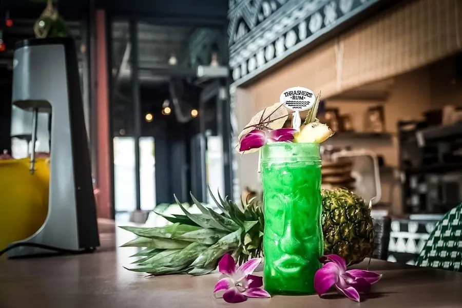 Green cocktail in tiki glass at Tiki TNT bar
