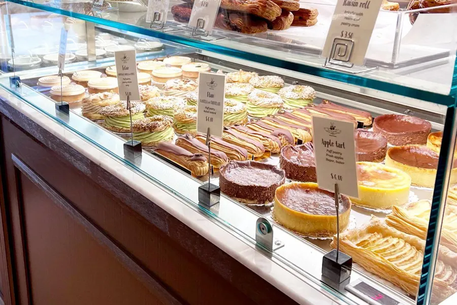 Colorful tarts and eclairs fill the pastry case at Un Je Ne Sais Quoi in Washington, DC’s Dupont Circle neighborhood.