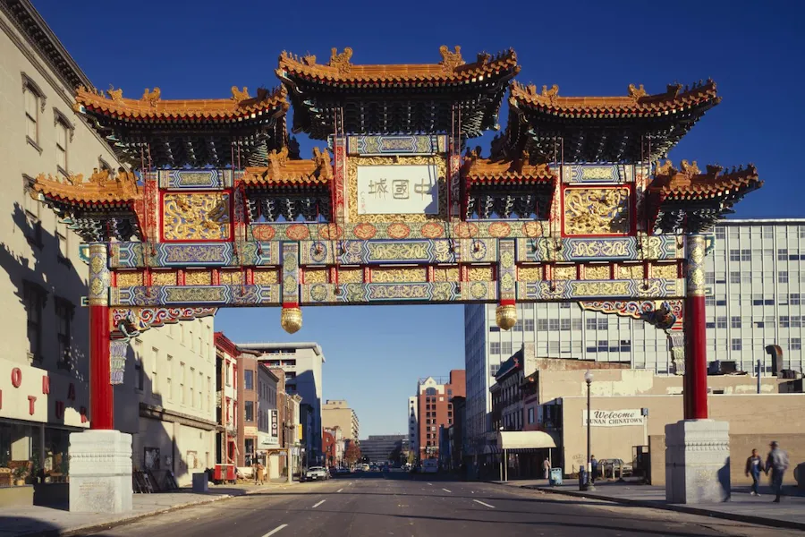 Colorful Friendship Archway in Washington, DC’s Chinatown spanning H Street NW under a clear blue sky.