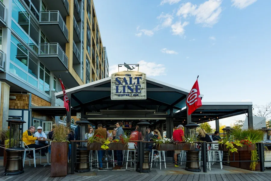 The outdoor patio of the Salt Line on a sunny day, decorate with nautical decor.