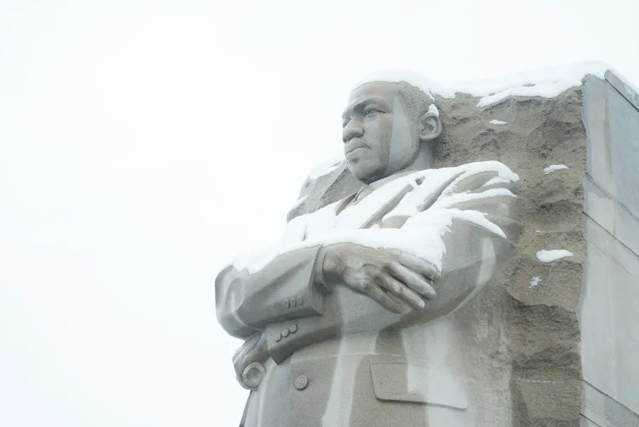 Snow rests on the stone figure of Martin Luther King Jr. at his Washington, DC Memorial.