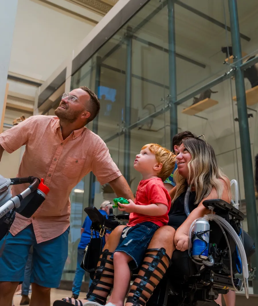 A family looks up at a soaring exhibit in a museum