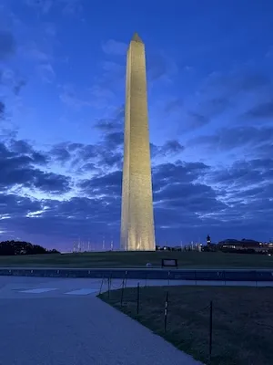 Washington Monument at dusk under a cloudy blue sky