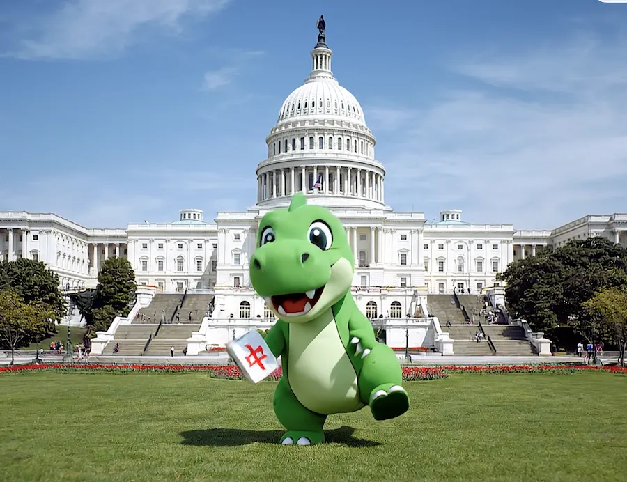 Cartoon green dinosaur holding a mahjong tile in front of the U.S. Capitol lawn