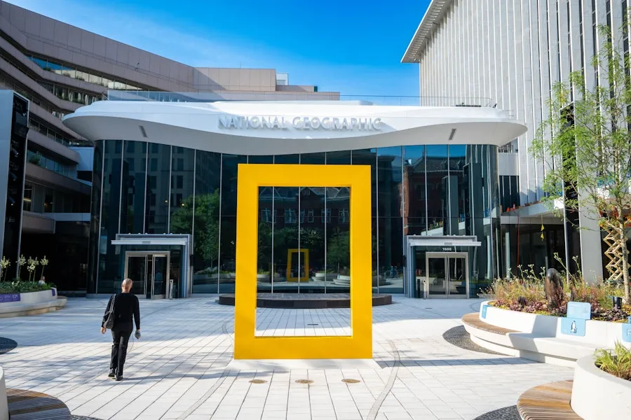 Modern courtyard with a large yellow rectangular frame sculpture