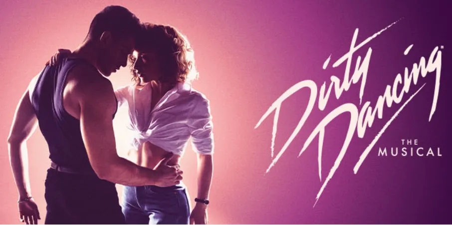 Photo of two dancers leaning in close under purple stage lighting
