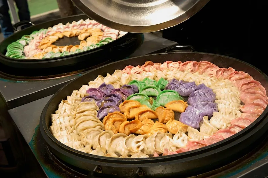 Platter of shrimp with dipping sauce and garnish on buffet counter