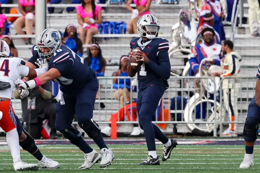 Howard University football player about to throw a ball