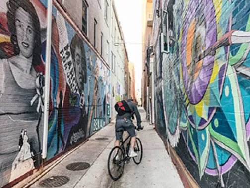 Biker going down mural alley
