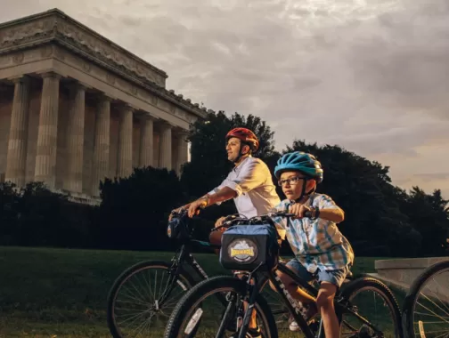 Family biking in front of Lincoln Memorial