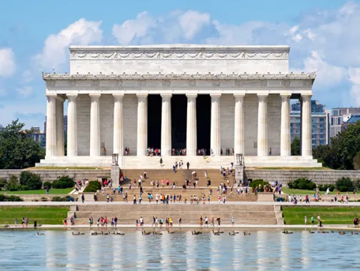 People on the steps of the Lincoln Memorial in front of the Reflecting Pool